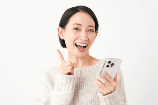 指を立てる笑顔の女性